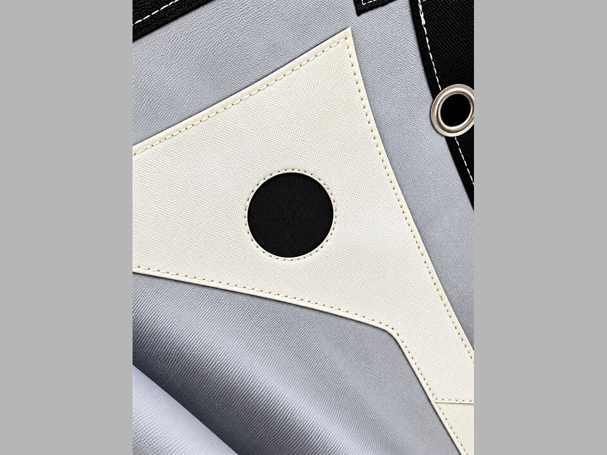 Corner of a DFR filter press cloth: reinforcement patch stitched over the cloth with a sealed eyelet through it